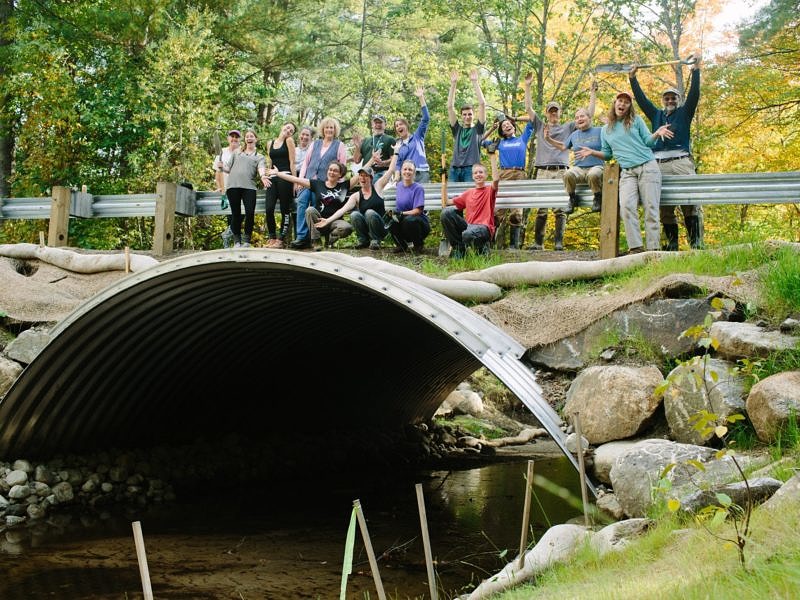 A volunteer crew mugs for the camera during a stream restoration workday in Swanzey, NH. (photo © Emily Lord/The Stewardship Network: New England))