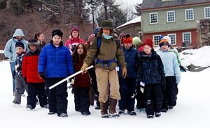 Susie Spikol leads a group of students on a winter tracking expedition. (photo © Eric Aldrich)