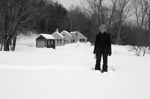 Jean Rosenthal stands in the snow on her conserved land in Harrisville, NH. (photo © Eric Aldrich)