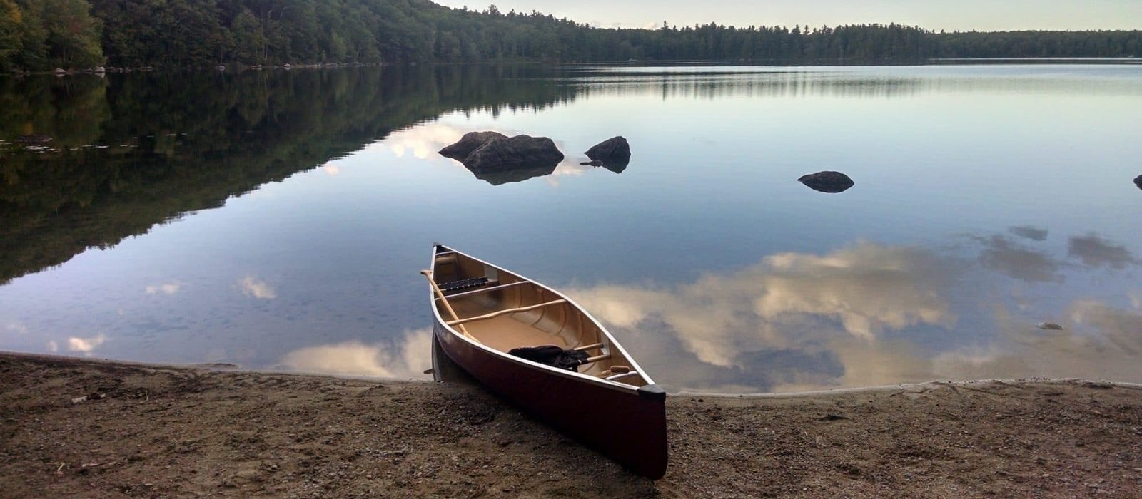 A canoe is ready to launch at Willard Pond, Antrim, NH. (photo © Brett Amy Thelen)