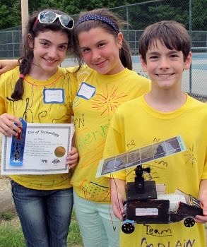 A middle school team shows off their winning solar-powered model car at the Solar Sprint, which is coordinated annually by the Harris Center. (photo © Brett Amy Thelen)