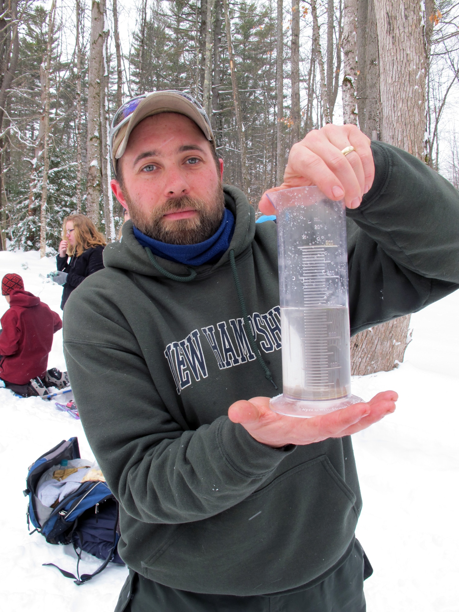 Otter Brook Farm manager Bryn Dumas shows off a graduated cylinder filled with melted snow. (photo © Brett Amy Thelen)