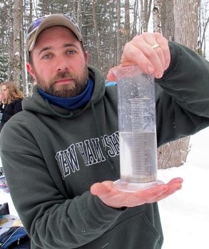 A researcher uses a graduated cylinder to measure the water content of the February snowpack. (photo © Brett Amy Thelen)