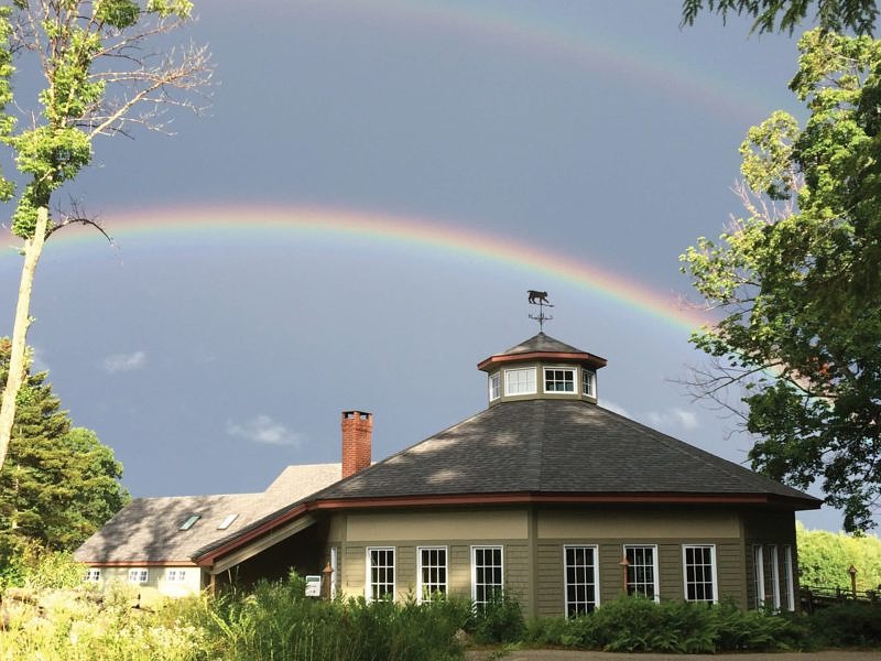 A rainbow arcs over the Harris Center building. (photo © Dottie Culinane)