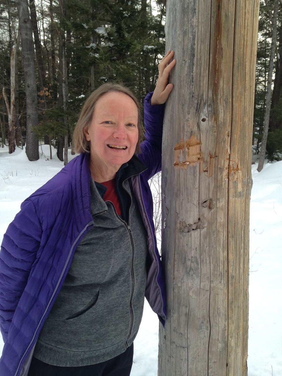 Janet Altobello, next to a bear-bitten telephone pole