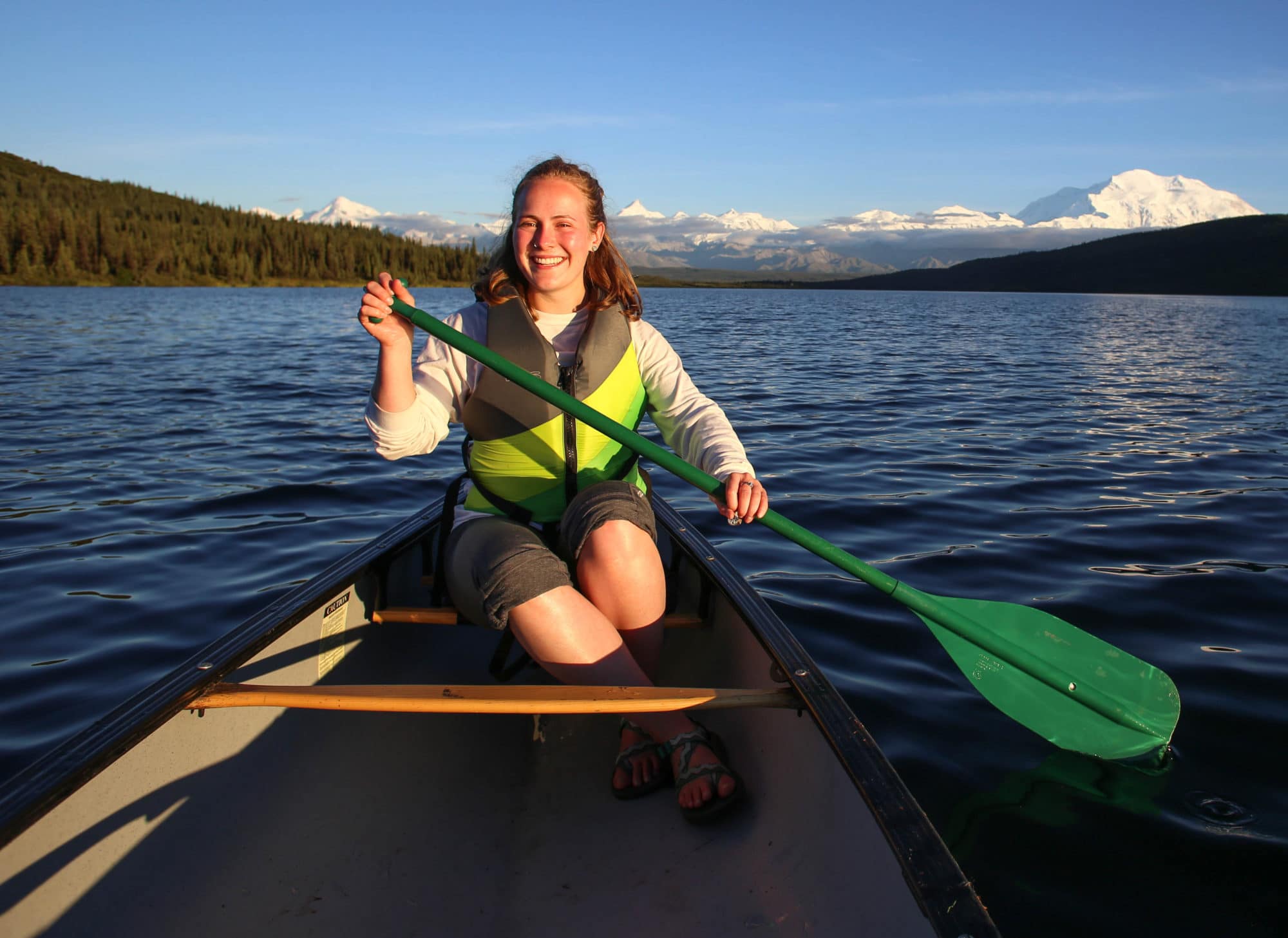 Kira Heeschen paddles a canoe in Alaska.