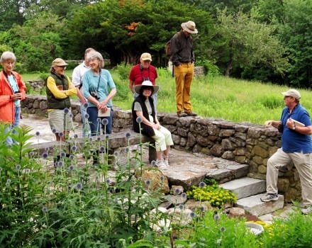 A group of butterfly enthusiasts stops by the pollinator garden in search of winged beauty. (photo © Brett Amy Thelen)