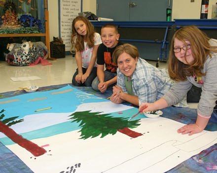 Antrim Elementary School students work on a mural depicting local wildlife with Harris Center naturalist Jenn Sutton.