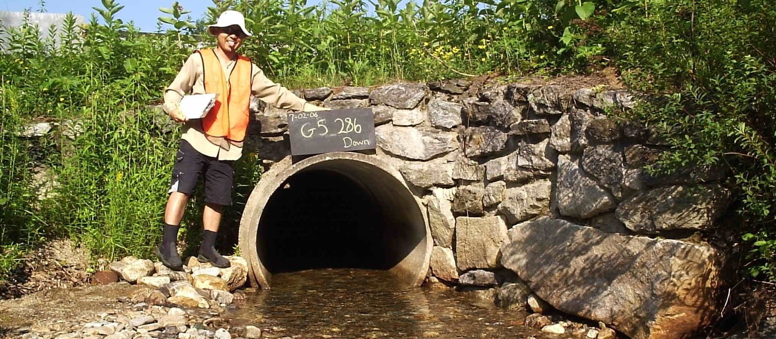 A citizen scientist surveys an undersized culvert in 2006.