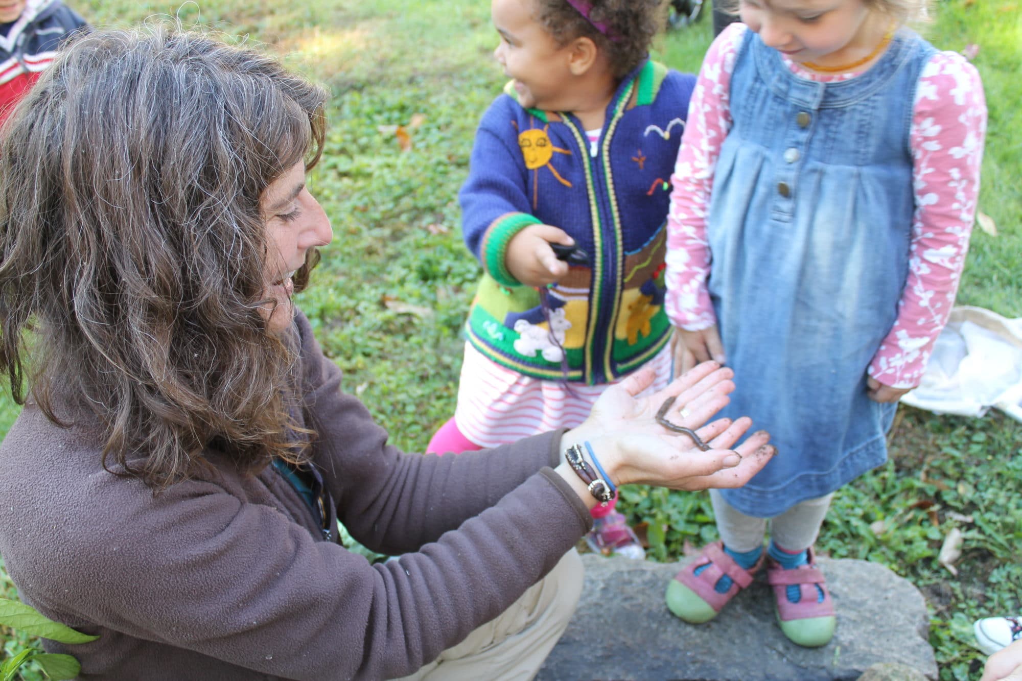 Harris Center naturalist Susie Spikol leads young children in a hands-on exploration of soil organisms.