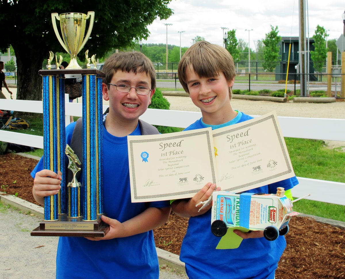 Ben Kriebel and Quinn Kelley from South Meadow School show off their trophy, awards, and creative solar-powered model car, which won first place for speed at the 8th Annual Monadnock Region Solar Sprint. (photo © Brett Amy Thelen)