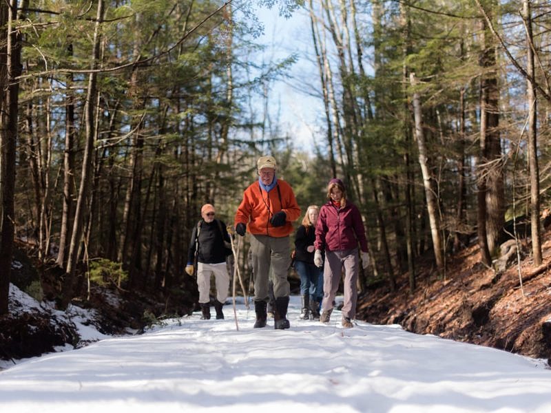 Meade Cadot leads a group of hikers on a winter stroll along the Jaquith Rail Trail. (photo © Ben Conant)