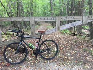 A bicycle rests at the gate to the Harris Center's Cadot Trail. (photo © Russ Cobb)