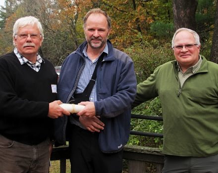 Harris Center Land Program Coordinator Eric Masterson (center) presented Ray Cilley (left) and American Steel with the 2018 Laurie Bryan Partnership Award. Dave Webb (right) of American Steel was also thanked for his invaluable contributions to last year's rail trail bridge installation.