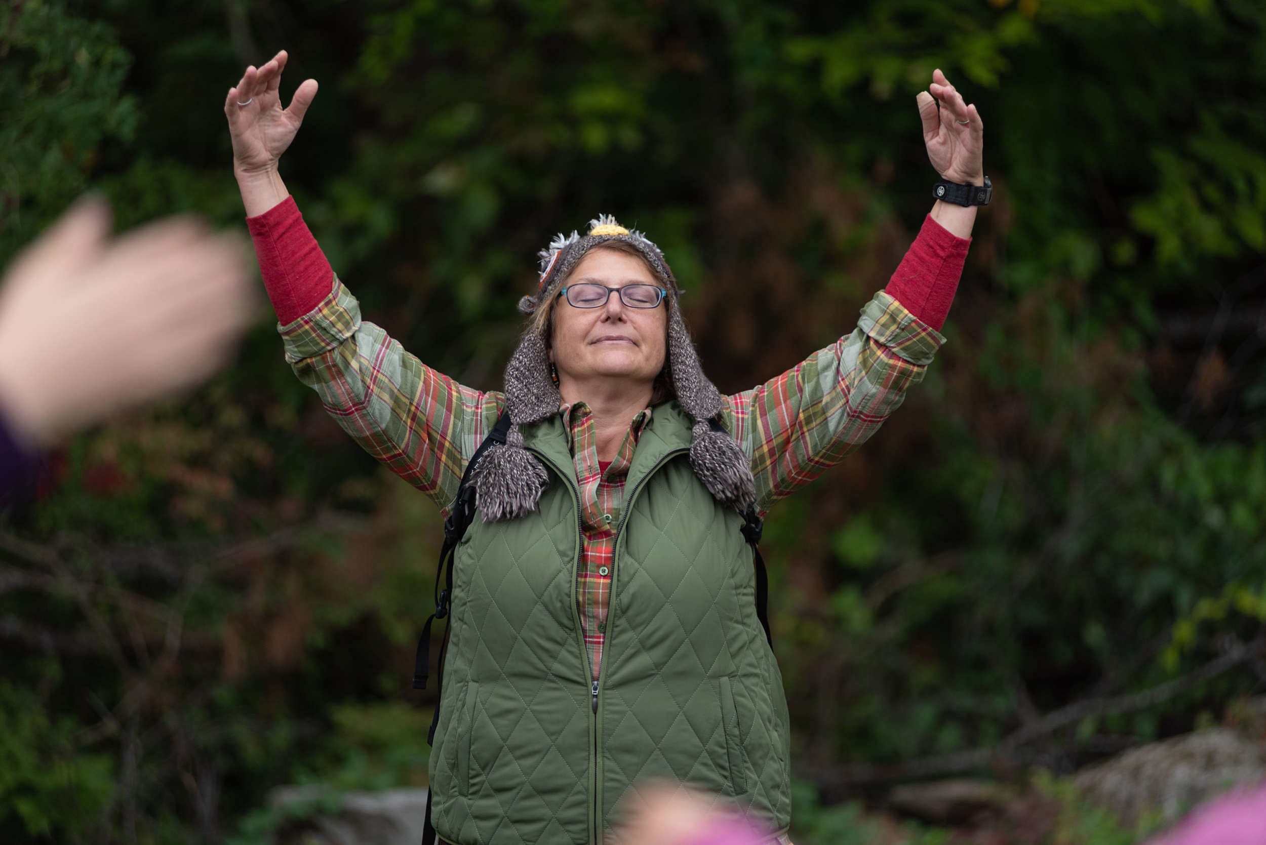 A woman takes a deep breath during a "Forest Bathing" workshop. (photo © Ben Conant)