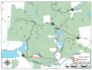 A map showing the Eastview Land (outlined in red) and Eastview Rail Trail, situated among a 5,155-acre block of conserved land (in green).