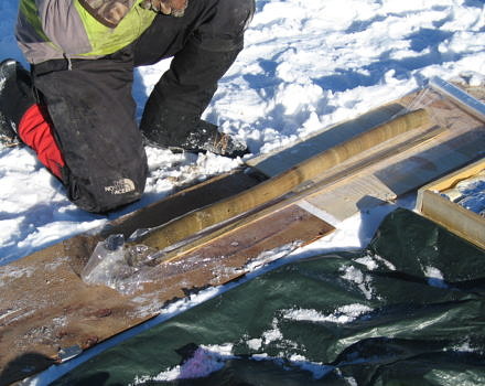 A researcher examines a newly-extracted lake sediment core. (photo © Montana State University Paleoecology Lab)