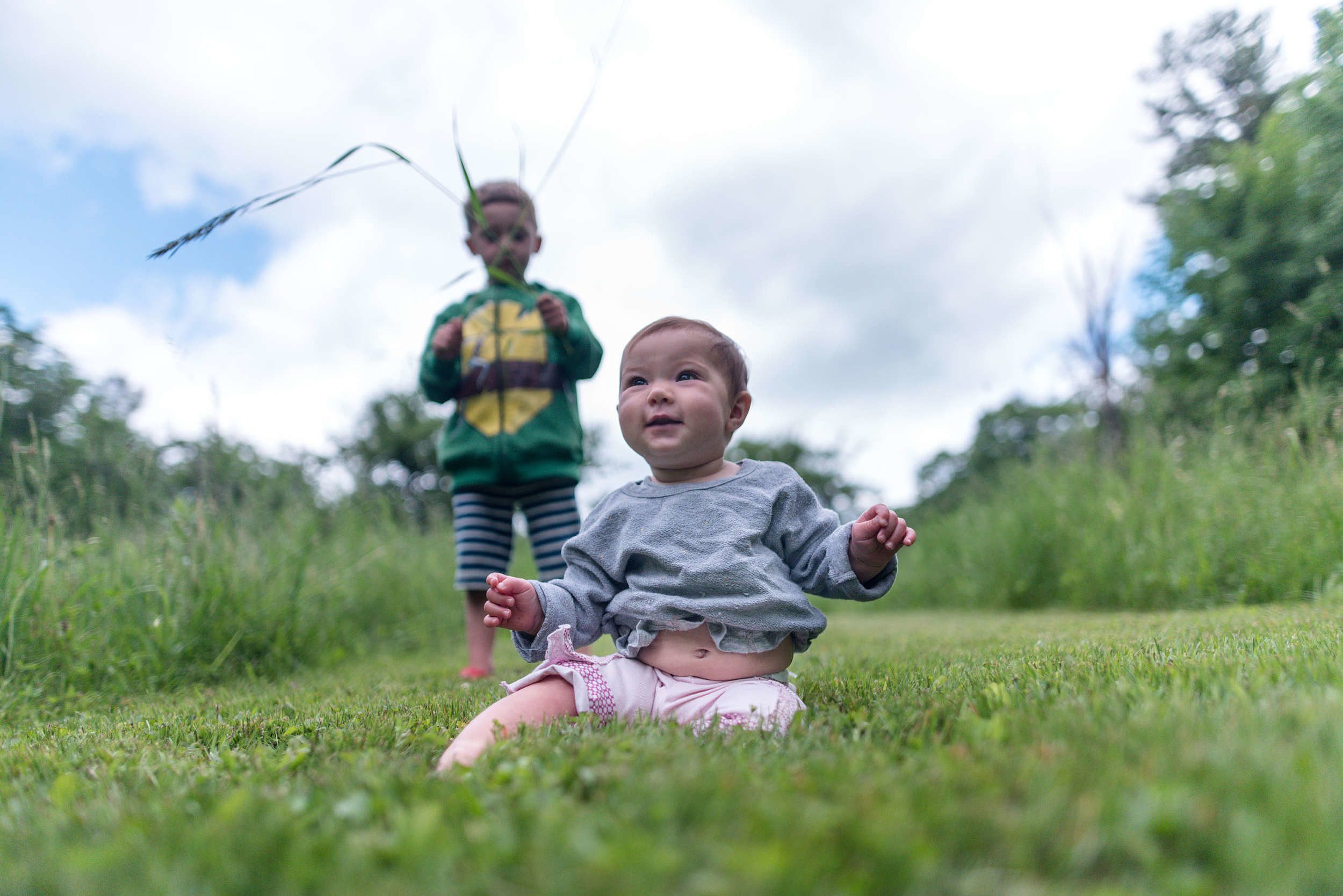 A baby and a toddler enjoy some outside time. (photo © Ben Conant)