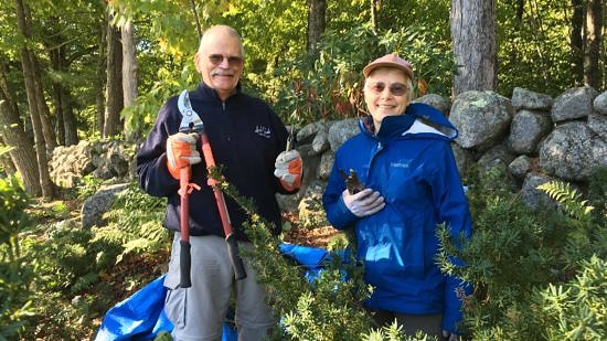 Lee and Jeanette Baker pose with loppers and work gloves while helping spruce up the Harris Center grounds for spring.
