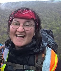 Alivia Acosta smiles on a backpacking adventure.