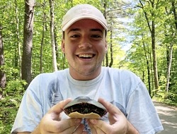 Gianni DeMasco holds a painted turtle.