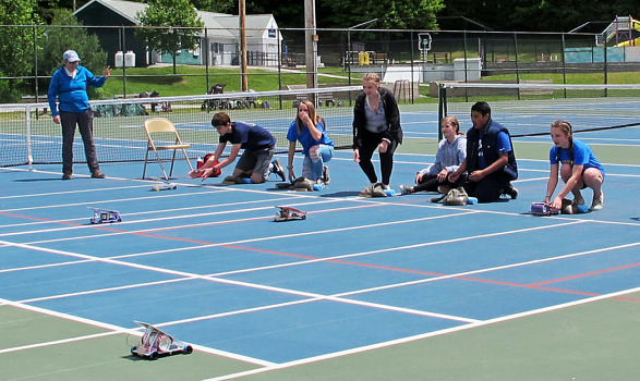 Middle school students cheer on their solar-powered model cars at the finish line of the 11th Annual Monadnock Region Solar Sprint.