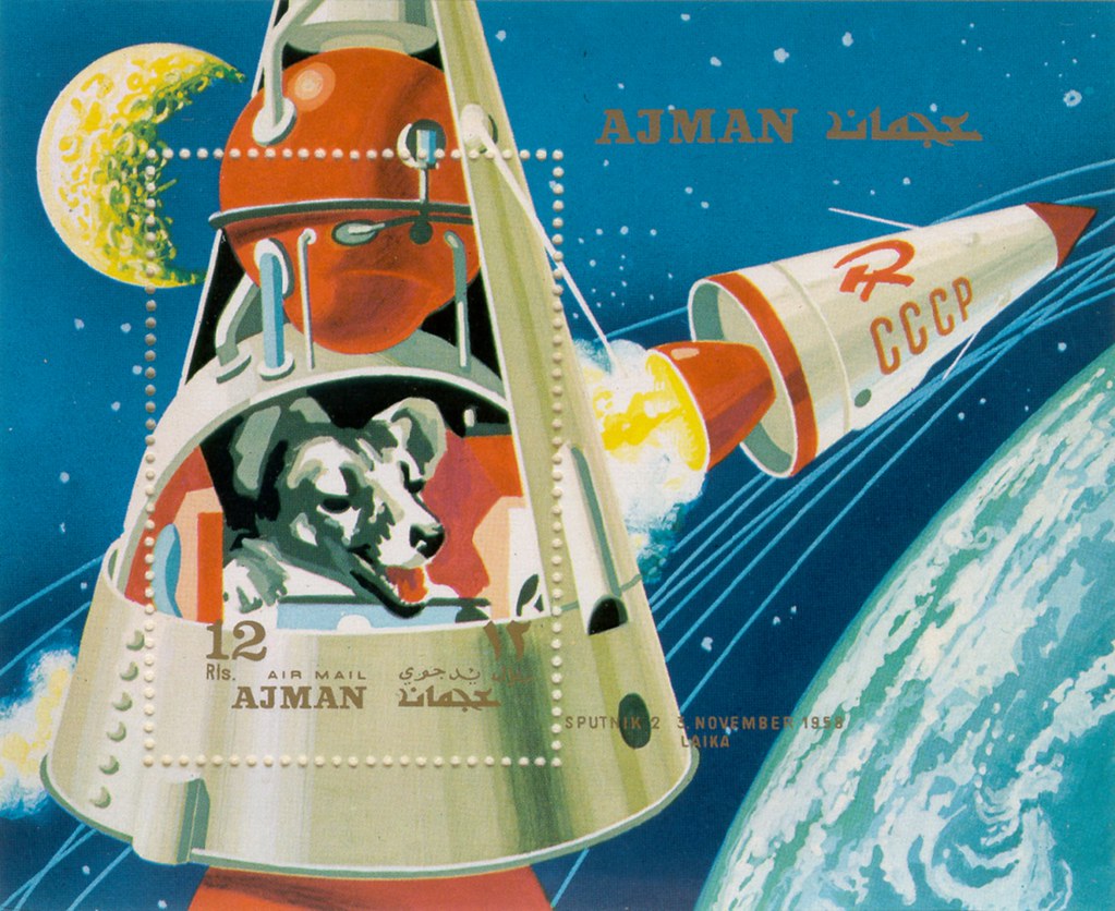 A vintage postage stamp depicting a dog in a space ship..