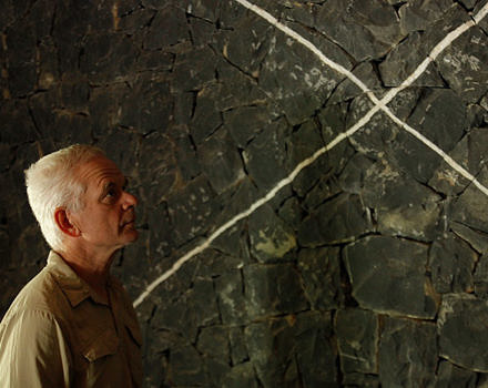Andy Goldsworthy in profile against a stone backdrop.