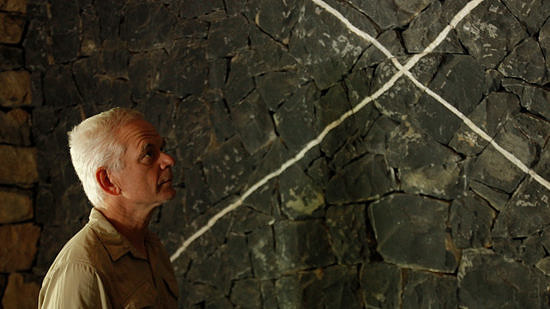 Andy Goldsworthy in profile against a stone backdrop.