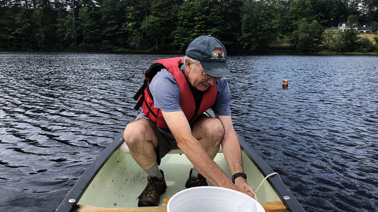 Norway Pond Commission chair Tom Shevenell sets a canoe anchor during a morning of water quality sampling on Norway Pond. (photo © Brett Amy Thelen)