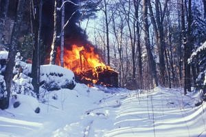 The old house at Rye Pond engulfed in flames on a snowy winter day. (photo © Meade Cadot)