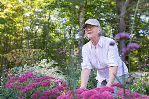 A photo of Sara LeFebvre in the Harris Center's pollinator garden.