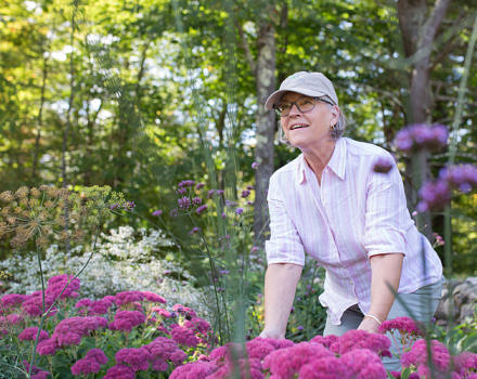 A photo of Sara LeFebvre in the Harris Center's pollinator garden.