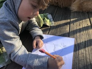 A child drawing a backyard map (photo © Ben Karen Rent)