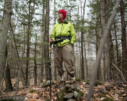 Dave Butler stands atop a stone wall on an early spring hike. (photo © Ben Conant)