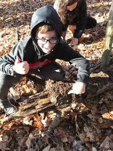 A child investigates a rotting log. (photo Jenna Spear)