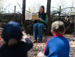 Harris Center naturalist Jaime Hutchinson reads a picture book to a group of children. (photo © Ben Conant)