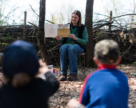 Harris Center naturalist Jaime Hutchinson reads a story book to a group of preschoolers. (photo © Ben Conant)
