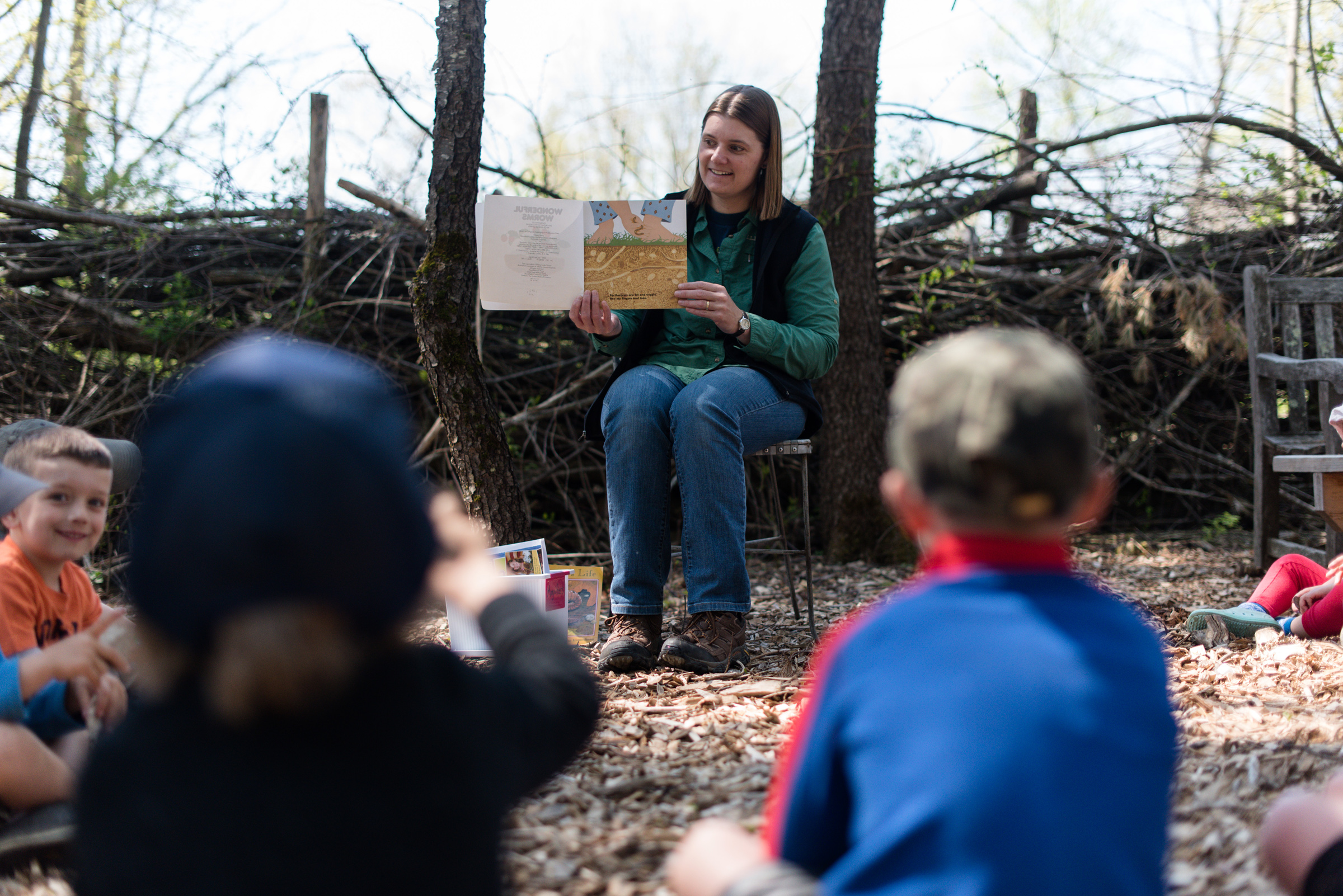 Harris Center naturalist Jaime Hutchinson reads a story book to a group of preschoolers. (photo © Ben Conant)