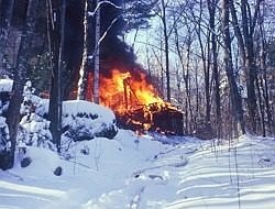 A burning house in a snowy wood.