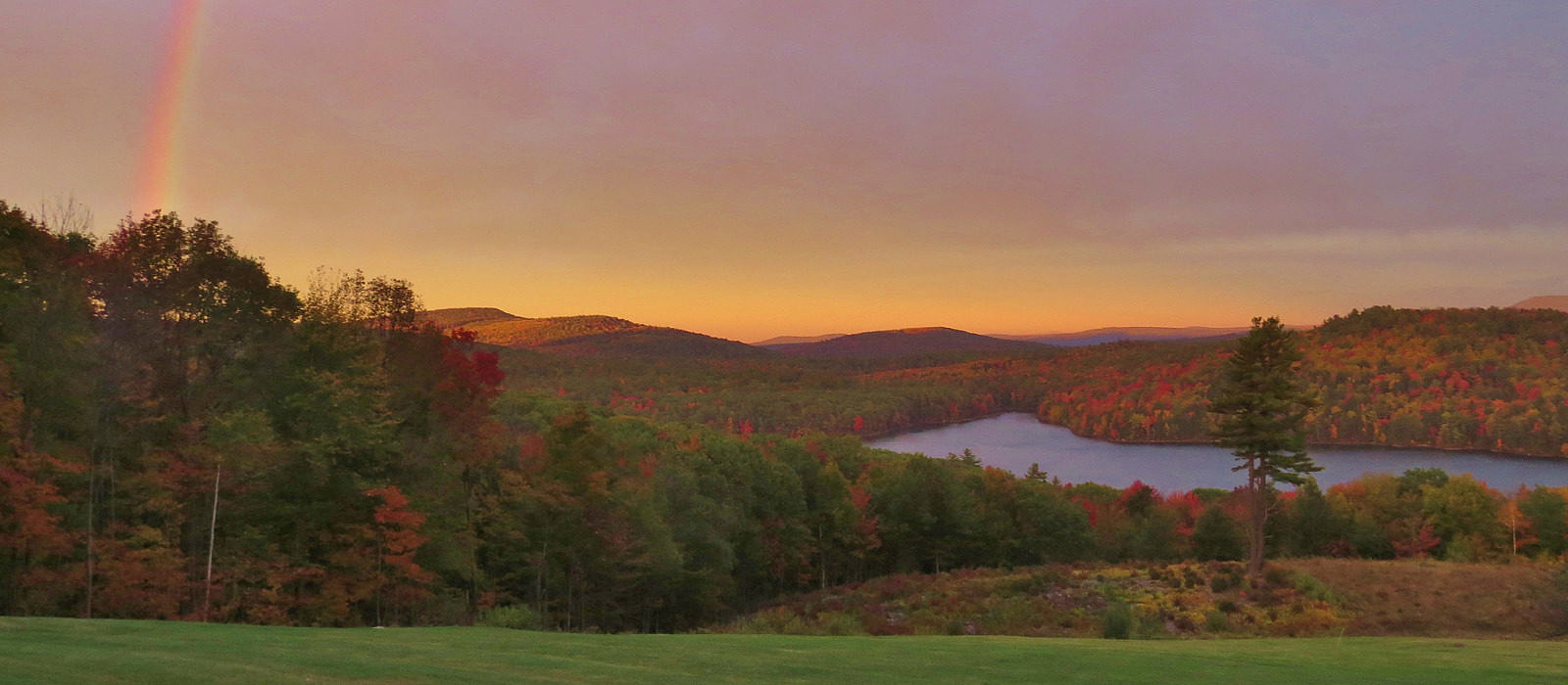 A rainbow over Spoonwood Pond, in autumn color. (photo © Meade Cadot)