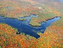 An aerial view of Robb Reservoir surrounded by fall foiliage. (photo © Eric Aldrich)