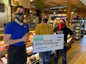 Nature's Green Grocer employees pose with a check
