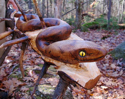 Jack's wooden snake slinks its way out of a downed spruce. (photo © Brett Amy Thelen)