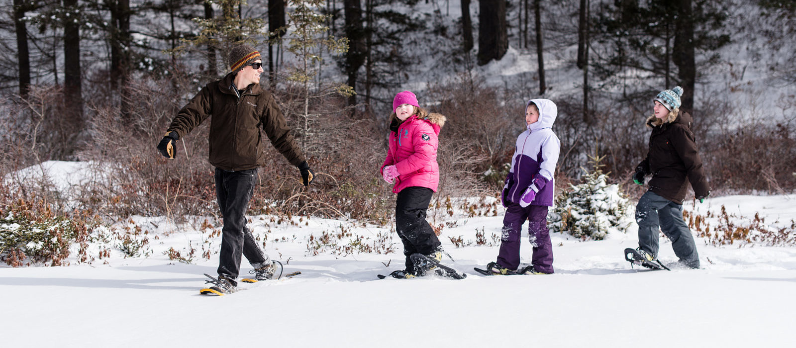 Harris Center naturalist John Benjamin leads 4th graders on a snowshoeing outing. (photo © Ben Conant)