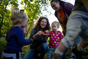 Naturalist Susie Spikol shares a wild find with toddlers, babies, and their parents during a Babies in Backpacks program. (photo © Ben Conant)