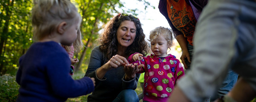 Harris Center naturalist Susie Spikol, surrounded by toddlers during a 