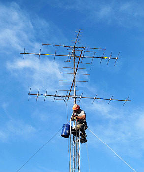 A technician installs antennas on the Motus receiving station at the Harris Center's Granite Lake Headwaters property. (photo © Brett Amy Thelen)