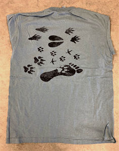 A light blue tee shirt printed with a variety of different animal tracks.