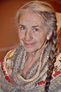 A photo of a woman with a long braid, wearing a thick winter sweater. (photo courtesy Sherry Gould)